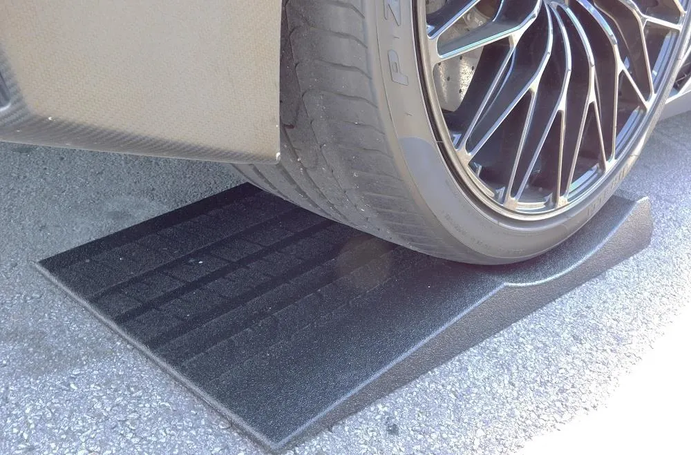 Car tire supported in a moulded cradle to spread load during long-term storage